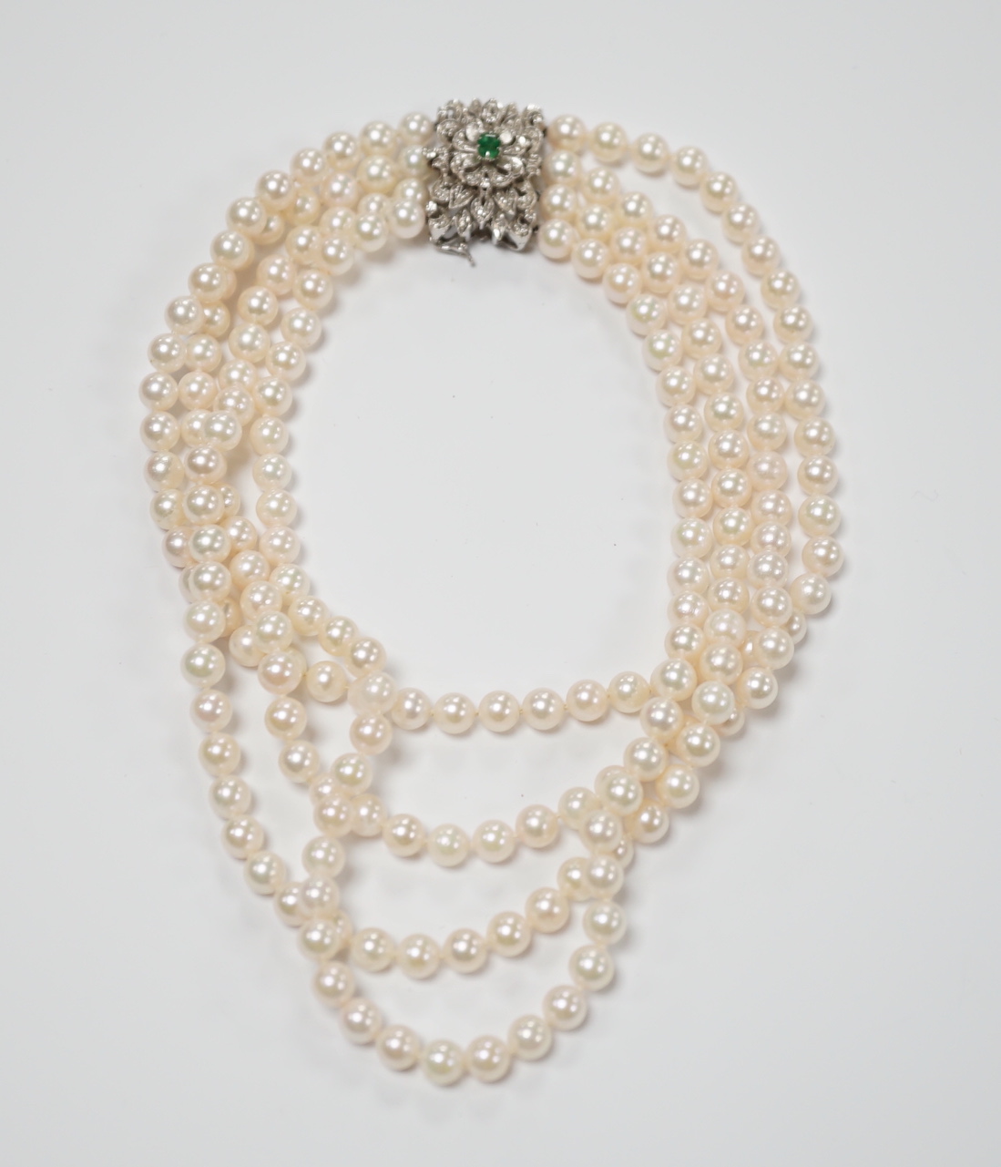 A quadruple strand cultured pearl choker necklace, with emerald and diamond chip set 750 white metal clasp, 32cm.